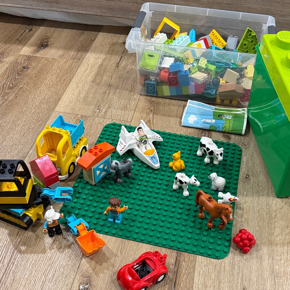 LEGO Duplo has a farm set and parts from a construction and buzz light year.